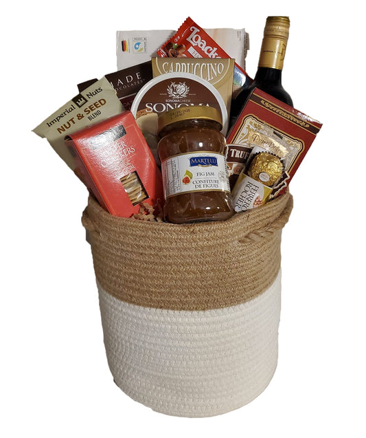 Wicker basket full of wine, cheese and treats
